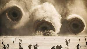 Enemy troops run as the Fremen forces attack the central outpost of the Harkonnens while riding on sandworms.