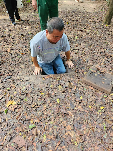 My dad going down one of the rat tunnel areas; This is the only one in the tour without a proper staircase opening, rather just a hole with staircases going directly down.